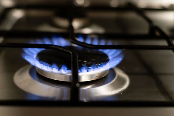 Blue gas flame on a cooktop burner