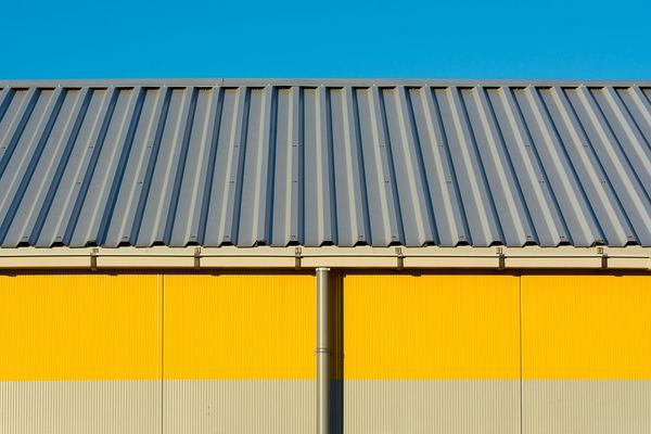 Corrugated metal roof with a gutter and downpipe